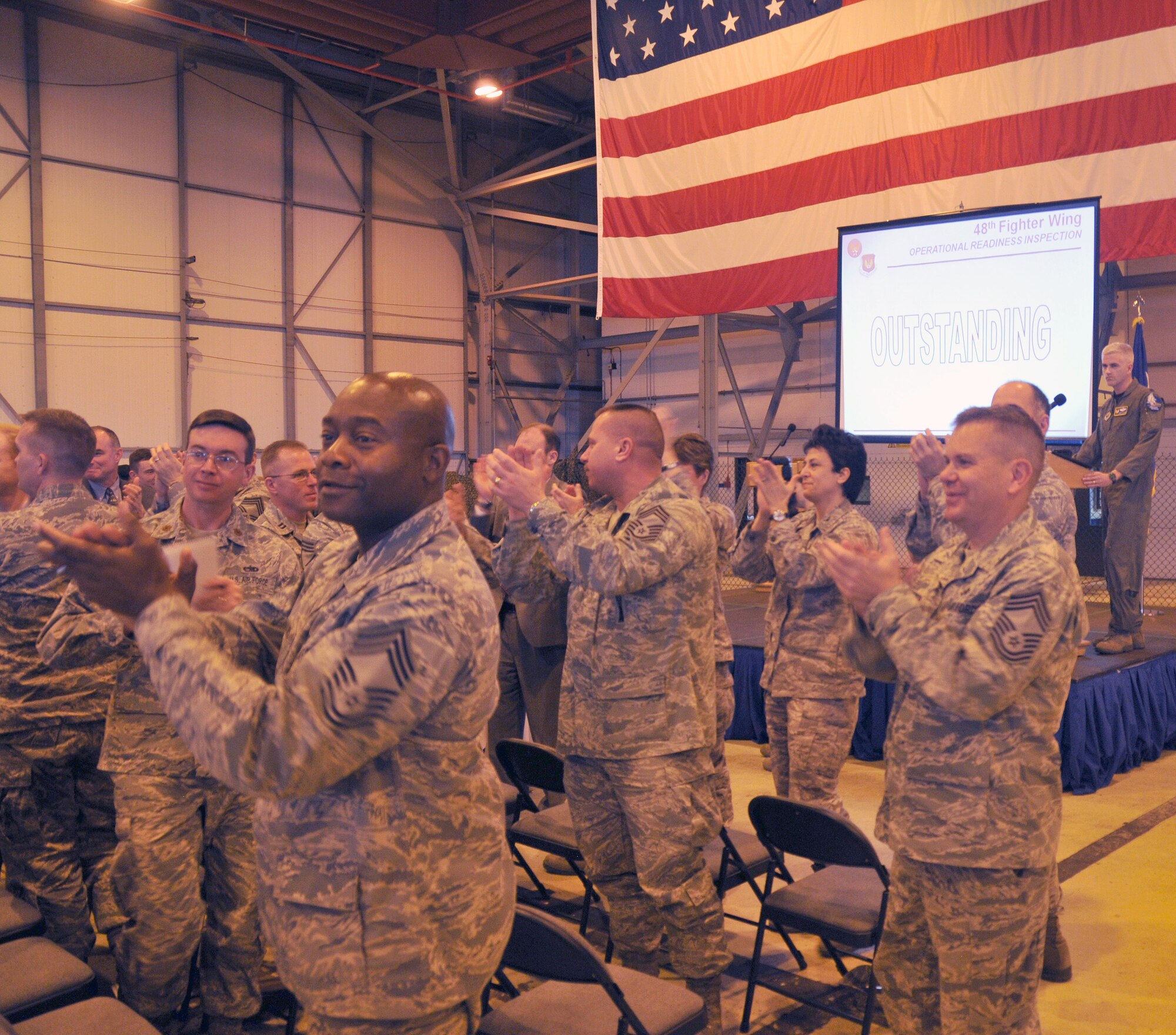 ROYAL AIR FORCE LAKENHEATH, England – 48th Fighter Wing leadership gives a standing ovation to Liberty Airmen after receiving an outstanding rating for the Operational Readiness Inspection in Hangar 6, Nov. 5.  The last outstanding rating for all U.S. Air Forces in Europe was 1986.  (U.S. Air Force photo/Staff Sgt. Connor Estes)