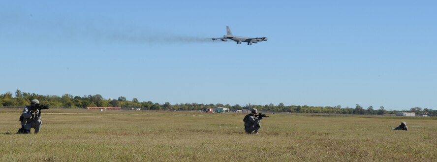 BARKSDALE AIR FORCE BASE -- Members of the 2nd Security Forces Squadron advance on a target during a training exercise for the Global Strike Challenge as a B-52H Stratofortress flies overhead Nov. 4. The challenge will the test the 2 SFS in different areas of their career field. (U.S. Air Force photo/2nd Lieutenant Victoria Lalich)(Released)