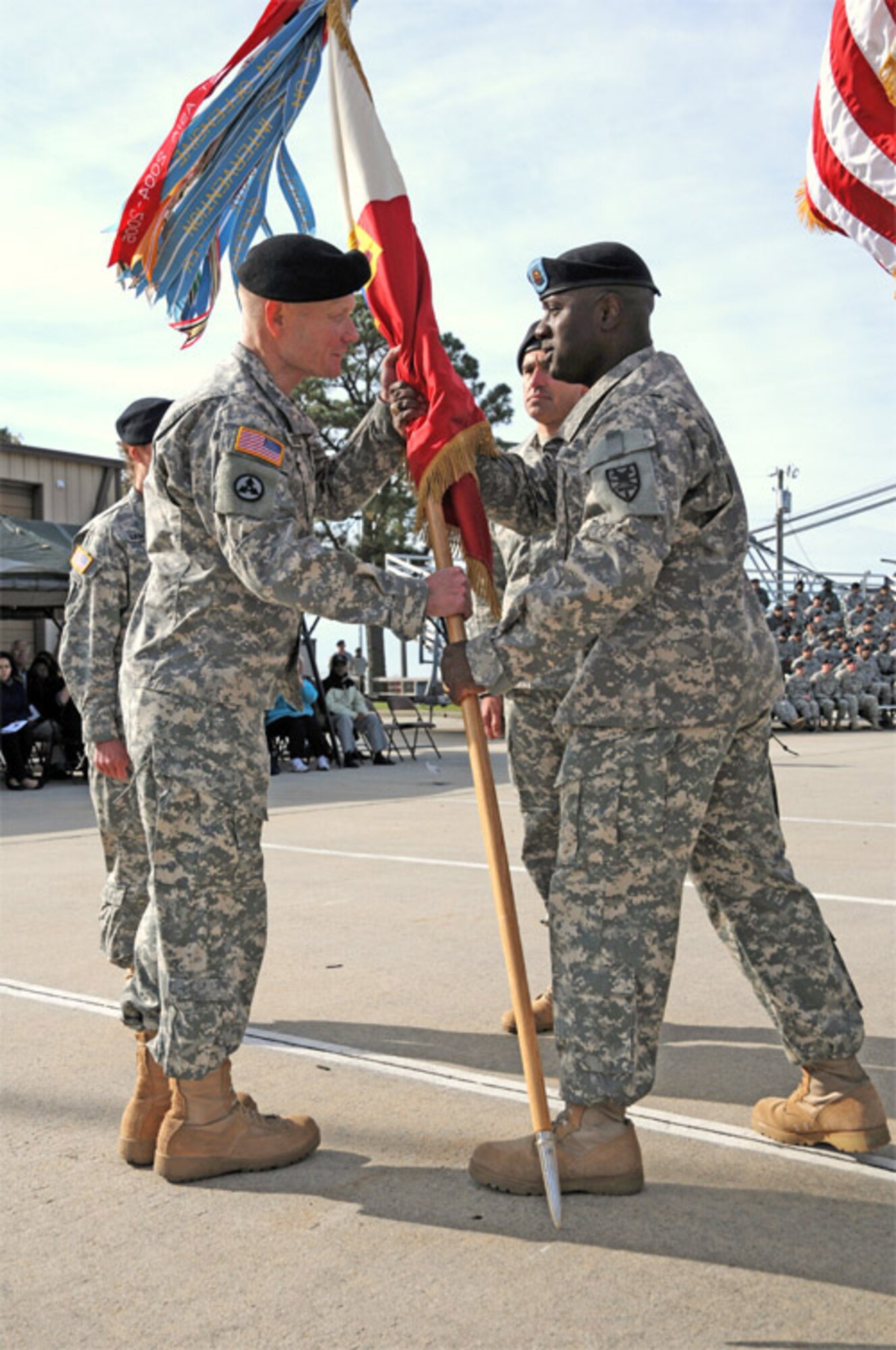 The passing of the colors is a historic part of the change of command and change of responsibility ceremony, as demonstrated by Command Sgt. Maj. Cedric J. Thomas, (right), the outgoing 7th Sustainment Brigade command sergeant major, as he passes the colors to Col. Charles F. Maskell, the outgoing 7th Sustainment Brigade commander, at Fort Eustis’ 3rd Port Tuesday.