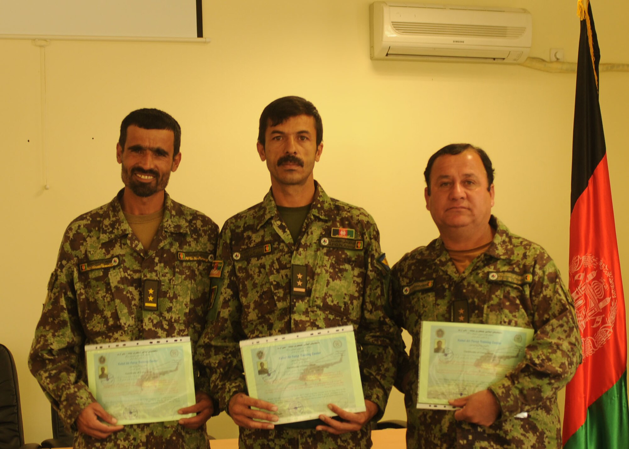 101104-N-6541W-019 KABUL, Afghanistan - Members of the Afghan Air Force graduate from Mi-17 Flight Engineer and Non Commissioned Officer Orientation courses at the Pohantoon-e-Hawayee (PeH), the Afghan Air Force training school on Nov.4th. (U.S. Navy photo by Mass Communication Specialist 3rd Class Jared Walker/ RELEASED).