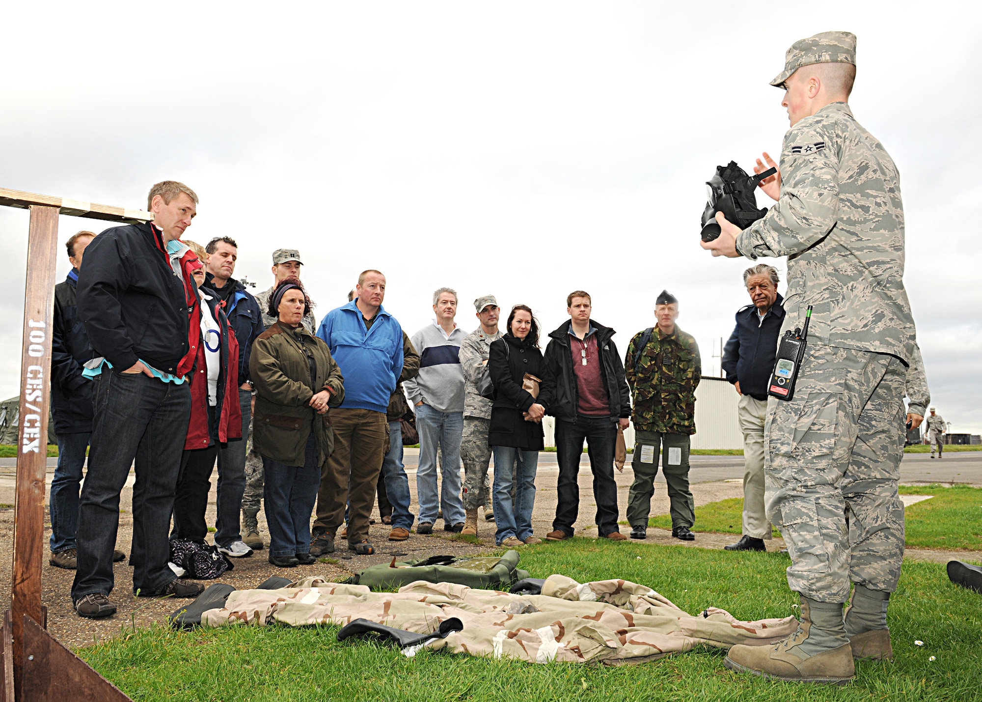 RAF MILDENHALL, England -- Airman 1st Class Charles Sweeney, 100th Civil Engineer Squadron hazardous material technician, briefs base and honorary commanders on chemical, biological, radiological, nuclear and environmental protective gear during the Honorary Commanders' Deployment Day here Nov. 4, 2010.  They day's events included equipment issue, pre-deployment briefings, a deployed style lunch and demonstrations from various career fields. (U.S. Air Force photo/Senior Airman Tabitha M. Lee)  