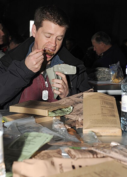 RAF MILDENHALL, England -- Adam Kendall, 100th Operations Support Squadron honorary commander, eats a meal ready-to-eat at his "deployed" location during the Honorary Commanders' Deployment Day here Nov. 4, 2010.  Honorary commanders ate the same meals that are issued to military members in field conditions.  (U.S. Air Force photo/Senior Airman Tabitha M. Lee)