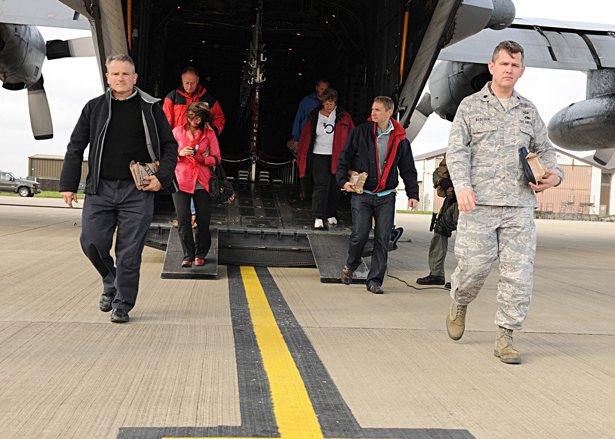 RAF MILDENHALL, England -- Base and honorary commanders disembark a MC-130H Combat Talon II at their "deployed" location during the Honorary Commanders' Deployment Day here Nov. 4, 2010.  The events of the day allowed the honorary commanders to catch a glimpse of what servicemembers experience when they deploy.  (U.S. Air Force photo/Senior Airman Tabitha M. Lee)