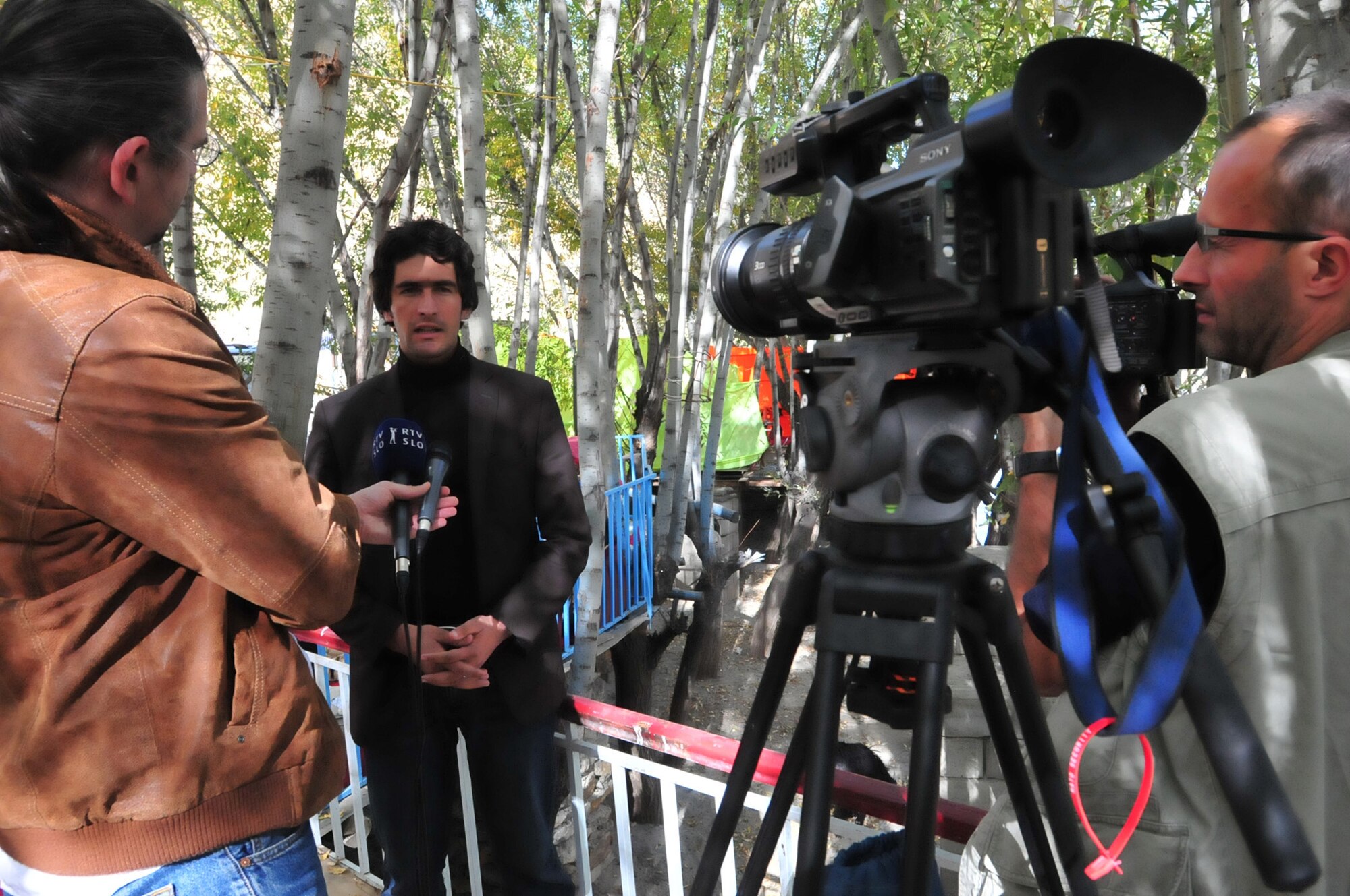 Igor Juric, TV Slovenia, and Donatas Stundis, LNK Television, interview Fahim Fetrat, Roz Afghan News, in Shutol District.  Journalists from France, Germany, Italy, Lithuania, Portugal and Slovenia visited Panjshir PRT as part of an eight-day tour of Afghanistan organized by the U.S. Mission to NATO with help from the U.S. Embassy Kabul. The media event provided the opportunity for the PRT to highlight the civilian and military partnership, its current activities and its efforts to promote a more effective Afghan government. (U.S. Air Force Photo by 1st Lt. Holly Hess, Panjshir PRT Public Affairs)