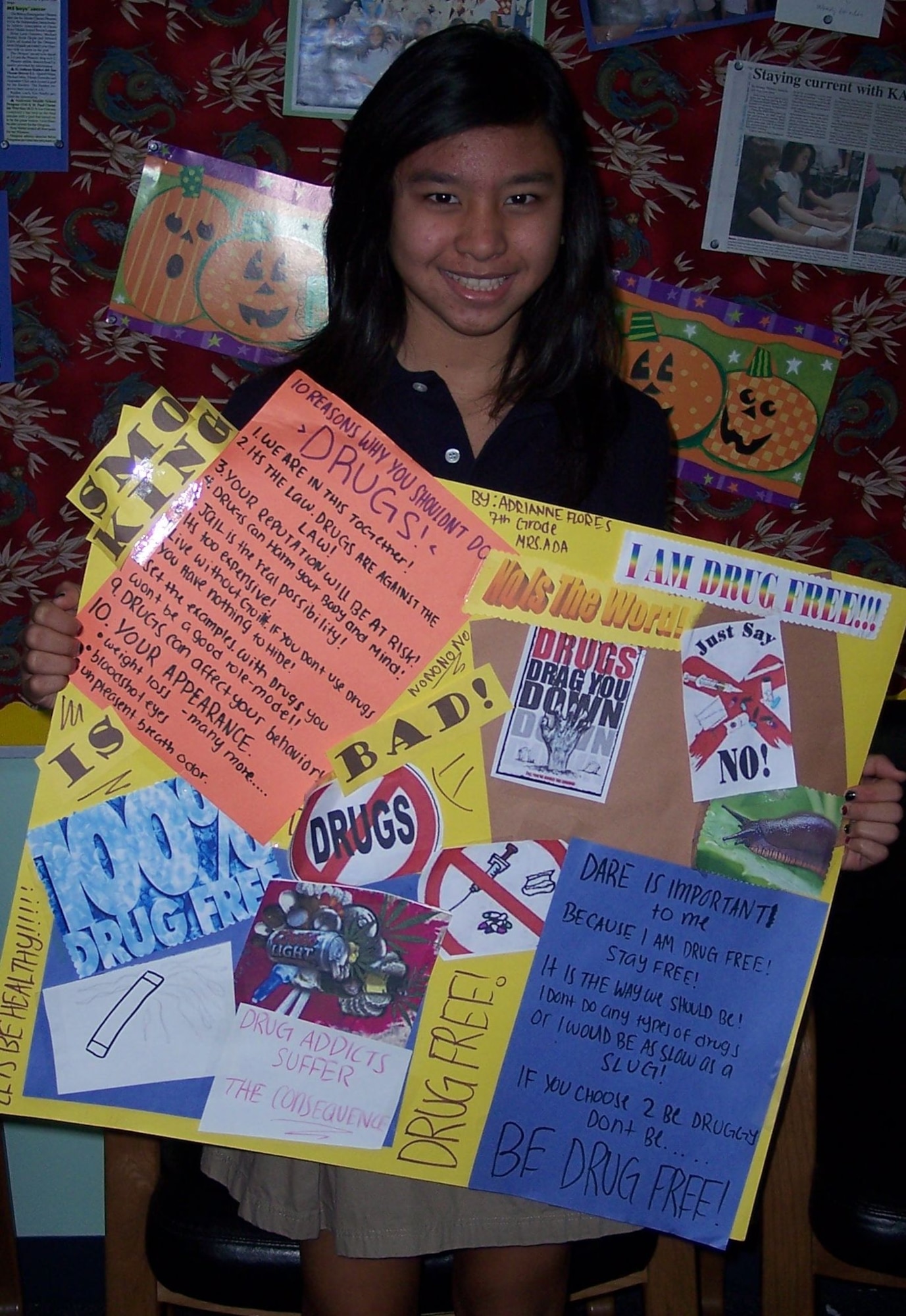 Andersen Middle School Student Adrianne Flores poses with her entry for the Drug Free Poster Contest sponsored by the Guam National Guard Counterdrug Program during Red Ribbon Week here Oct. 18. Not only did Adrianne win at Andersen Middle School, but her poster took first place in the island-wide competition.(U.S. Air Force Courtesy Photo)

