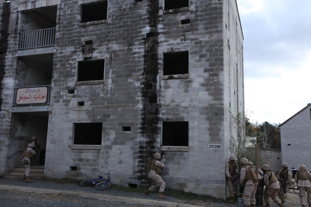 Marines with Provisional Security Platoon, 1st Supply Battalion, 4th Marine Logistics Group stack up and began to clear a building containing Marines playing the roll of mock enemy insurgents counter improvised explosive device during training Nov. 5.