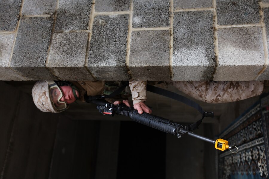 Lance Cpl. Brett Fedeler, an automotive intermediate mechanic with Provisional Security Platoon, 1st Supply Battalion, 4th Marine Logistics Group peers out of his concealed position looking out for additional mock enemy fighters during counter improvised explosive device during training Nov. 5.