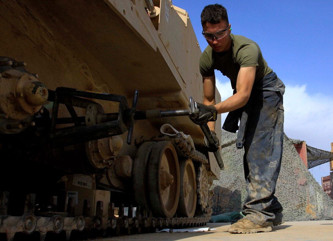 Lance Cpl. Forest Goodbar, 20, heavy equipment mechanic, Support Company, Combat Logistics Battalion 3, 1st Marine Logistics Group (Forward), detaches a piece of equipment from a M9 Armored Combat Earth-Mover at Camp Dwyer, Afghanistan, Nov. 5. Goodbar and nine other Marines with CLB-3's heavy equipment maintenance section are tasked with maintaining vehicles for several units throughout Afghanistan's Helmand Province.