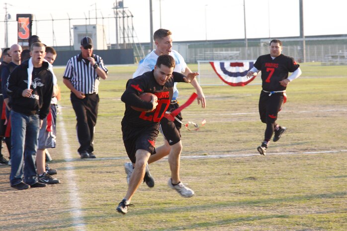 Garrit Fox, middle linebacker and offensive lineman for the IYAOYAS, tip toes down the line to gain a few extra yards after a reception during the championship game of the 9th annual Turkey Bowl flag football tournament at the Penny Lake football field here Saturday. The IYAOYAS destroyed the Vikings 31-13 to remain undefeated during the tournament.