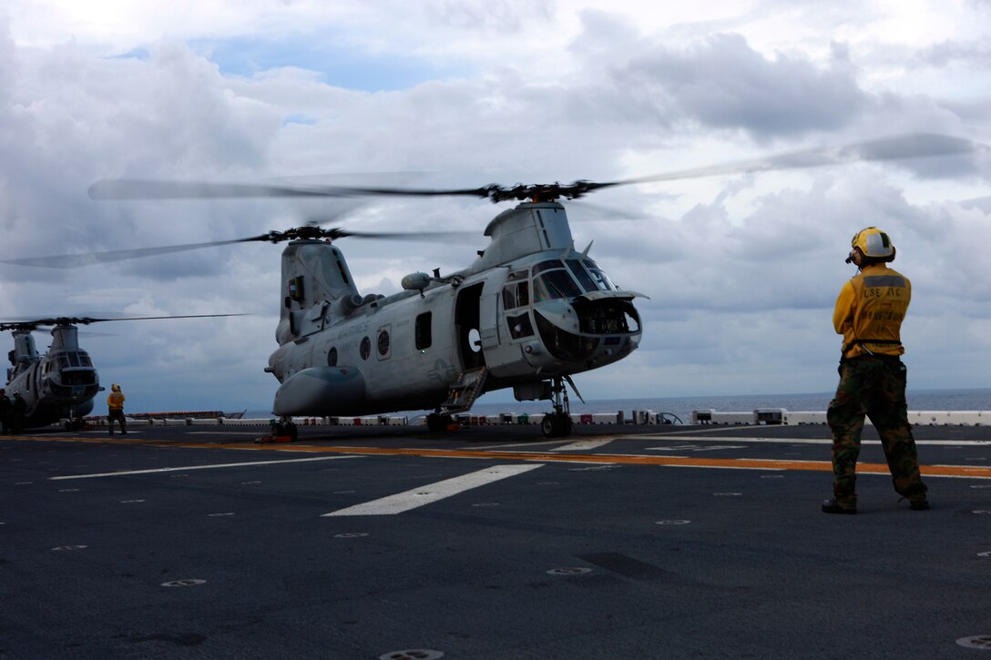 U.S. Marines and sailors deployed in support of Operation Continuing Promise 2010 and embarked aboard the amphibious assault ship USS Iwo Jima, prepare to depart on a site survey via medium-lift, dual rotor CH-46E Sea Knight helicopters with Marine Medium Helicopter Squadron 774, attached to Special-Purpose Marine Air-Ground Task Force CP10, in the area of Port-Au-Prince, Haiti, Nov. 6, 2010, to gather an understanding of the damage caused by Hurricane Tomas. If tasked, the USS Iwo Jima will conduct humanitarian relief operations in support of the government of Haiti, MINUSTAH and USAID. Service members and civilians are deployed in support of CP10 providing medical, dental, veterinary, engineering assistance and subject-matter exchanges to the Caribbean, Central and South America.