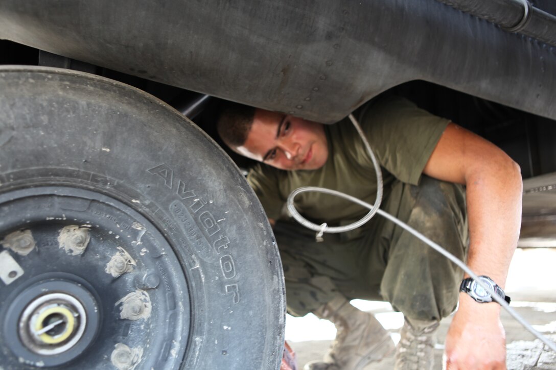 Corporal Luis M. Rodriguez, an airframes mechanic with Marine Medium Tiltrotor Squadron 266 (Reinforced), 26th Marine Expeditionary Unit, services a main landing gear shock strut of a CH-53E Super Stallion Helicopter at Pano Aqil Cantonment, Pakistan, Nov. 6, 2010. With the Pakistan military, 26th MEU Marines have been flying CH-53E Super Stallion Helicopters to isolated locations since early September and have transported more than 3.9 million pounds of World Food Programme flood relief supplies to 150 different locations in southern Pakistan. (Official USMC photo by Gunnery Sgt. Bryce Piper) (Released)::r::::n::