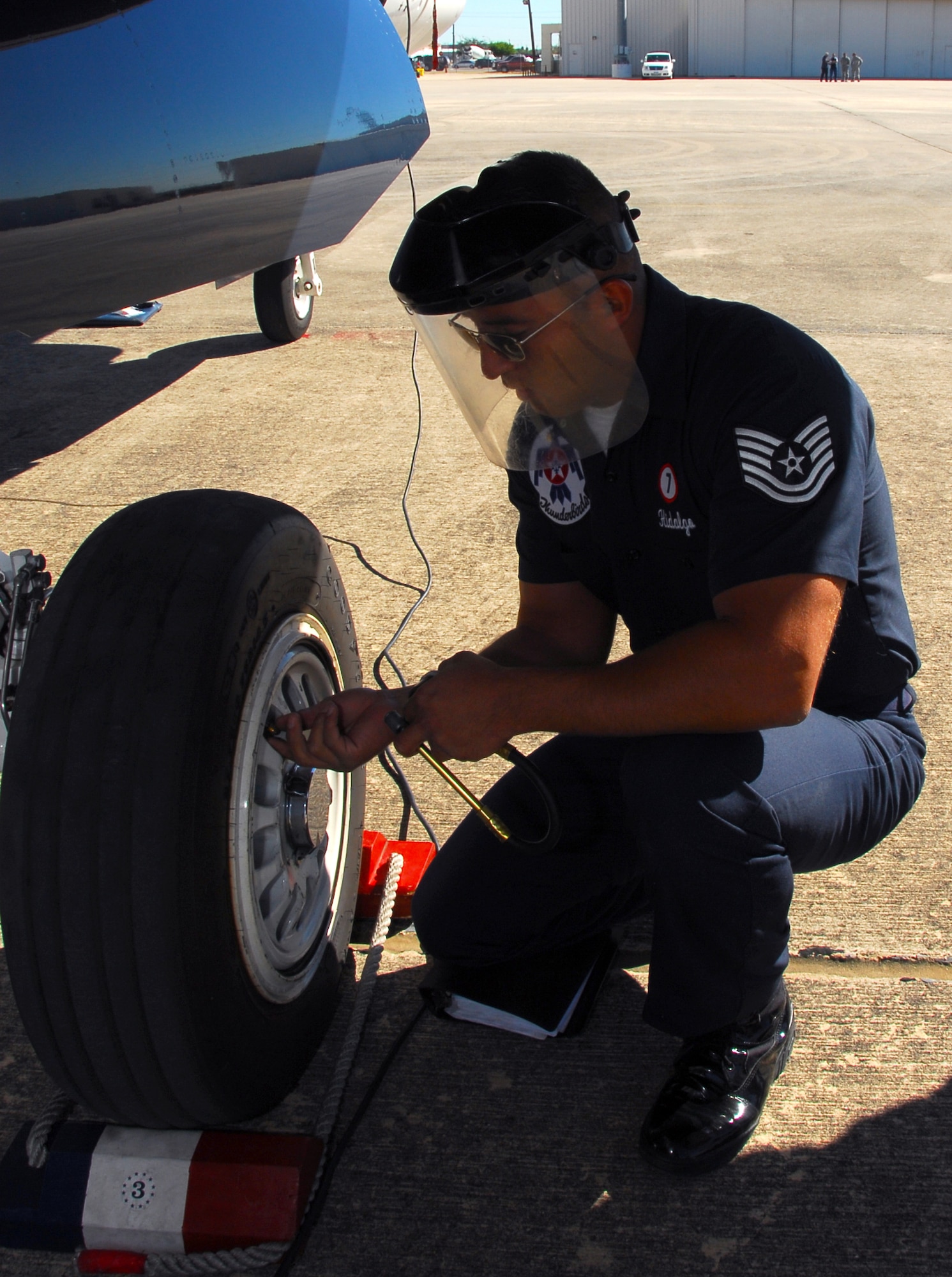 Tech. Sgt. Jose Hidalgo checks the tire pressure on an Air Force Thunderbird F-16 Fighting Falcon during his pre-inspection Nov. 5, 2010, at Lackland Air Force Base, Texas. Sergeant Hidalgo is a Thunderbirds assistant crew chief.  The air demonstration team was at Lackland AFB to perform during AirFest 2010.  (U.S. Air Force photo/Staff Sgt Jamie Powell)