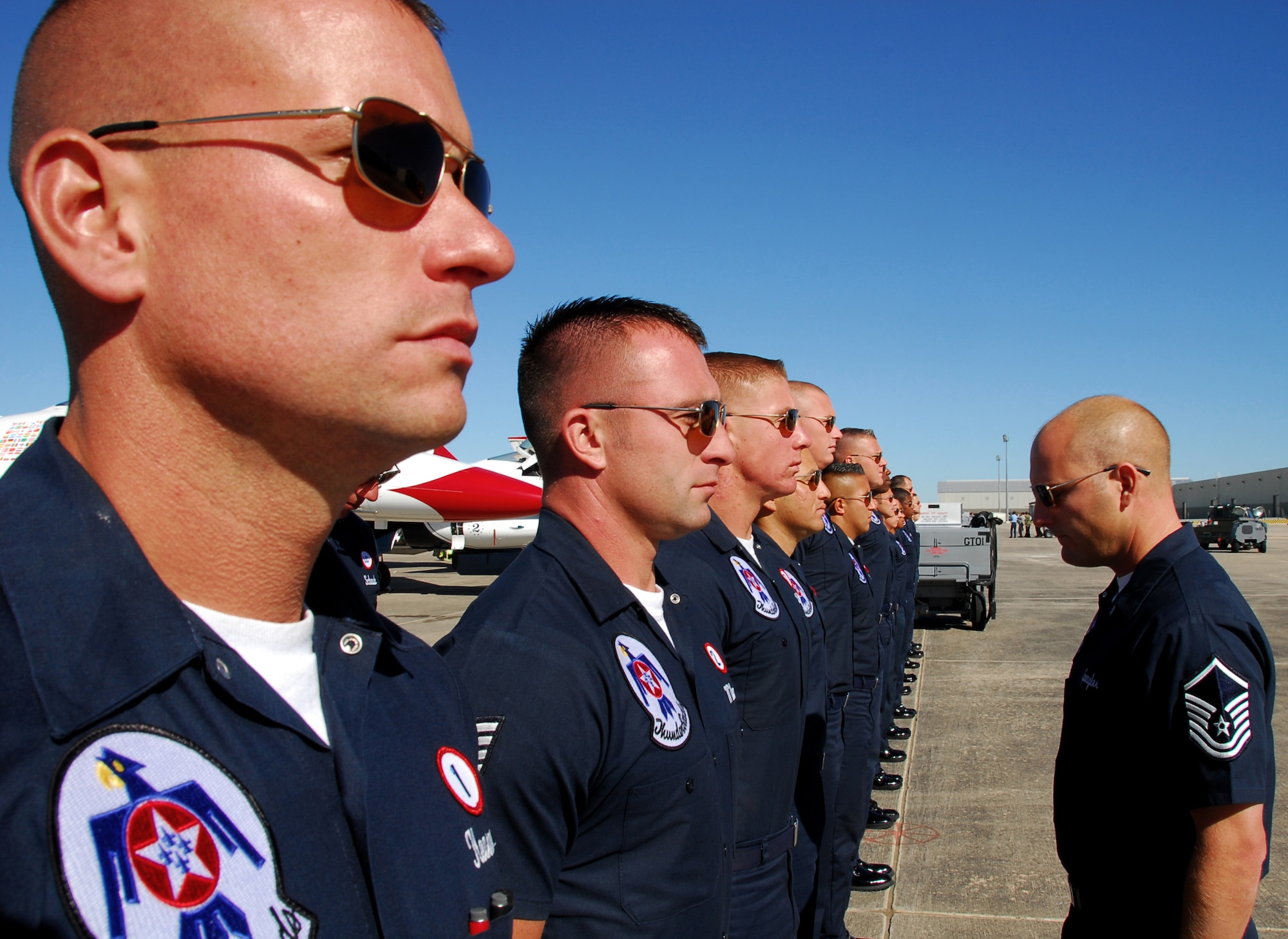 Before starting their aircraft pre-inspections Nov. 5, 2010, for an air show taking place Nov. 6 and 7 at Lackland Air Force Base, Texas, Air Force Thunderbird maintainers are inspected during open ranks. The Thunderbirds team is made up of 12 officers and more than 120 enlisted maintenance and support Airmen. (U.S. Air Force photo/Staff Sgt. Jamie Powell)