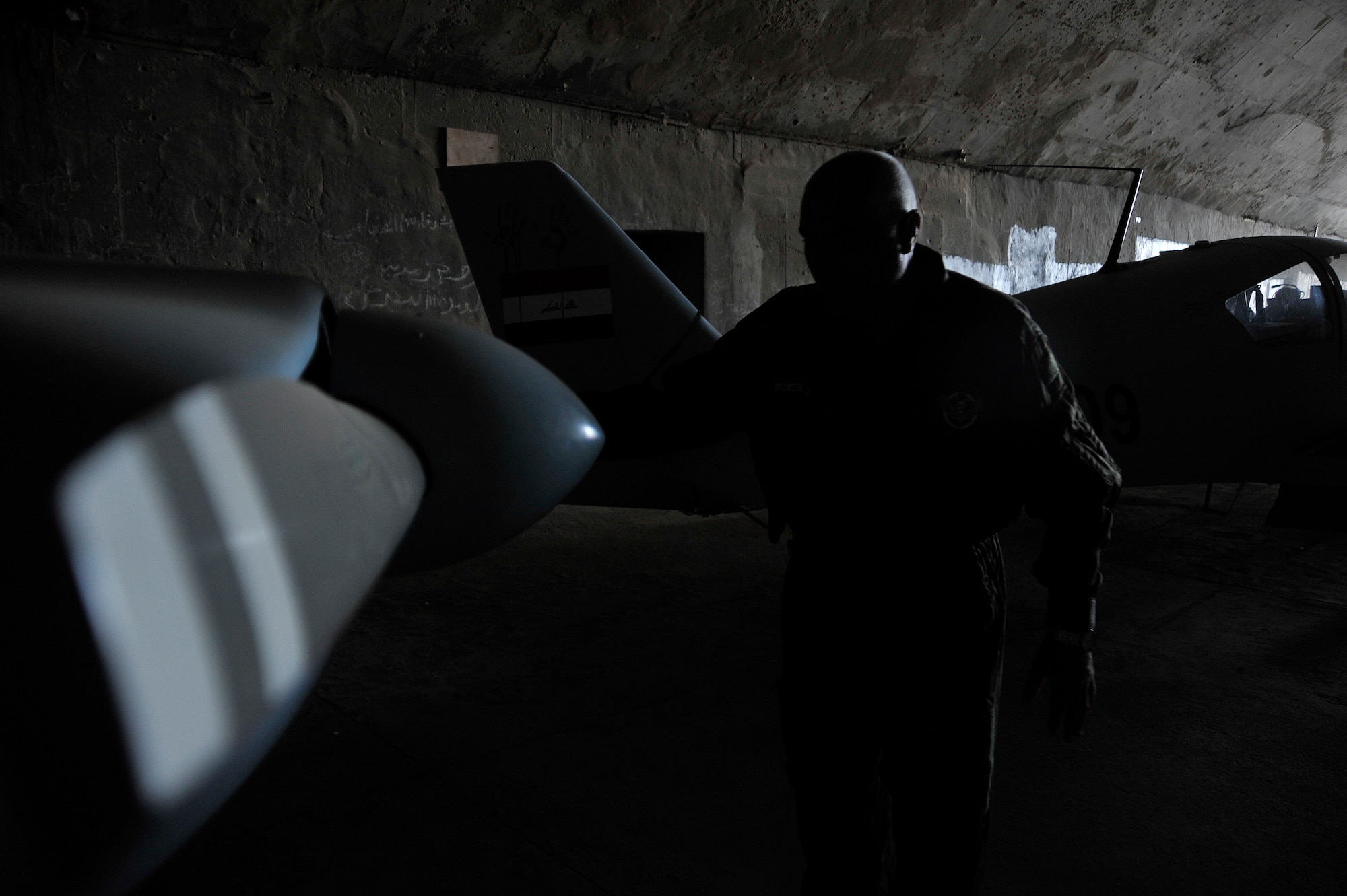 Iraqi air force airmen check their CH2000 for any damage after a sand storm, Oct. 24, 2010, at Ali Air Base, Iraq, after being transferred from Basrah Air Base by the Iraqi Ministry of Defense.  Iraqi air force Squadron 70 flies intelligence, surveillance and reconnaissance missions. After moving, Sq. 70 flew their first mission from Ali Base with U.S. Army AH-64 Apaches Oct 25, 2010, providing ISR security of the Hajj - an annual pilgrimage of citizens to Mecca - while also providing ISR support of a main supply route and oil pipeline. (U.S. Air Force photo by Senior Airman Perry Aston) (Released)