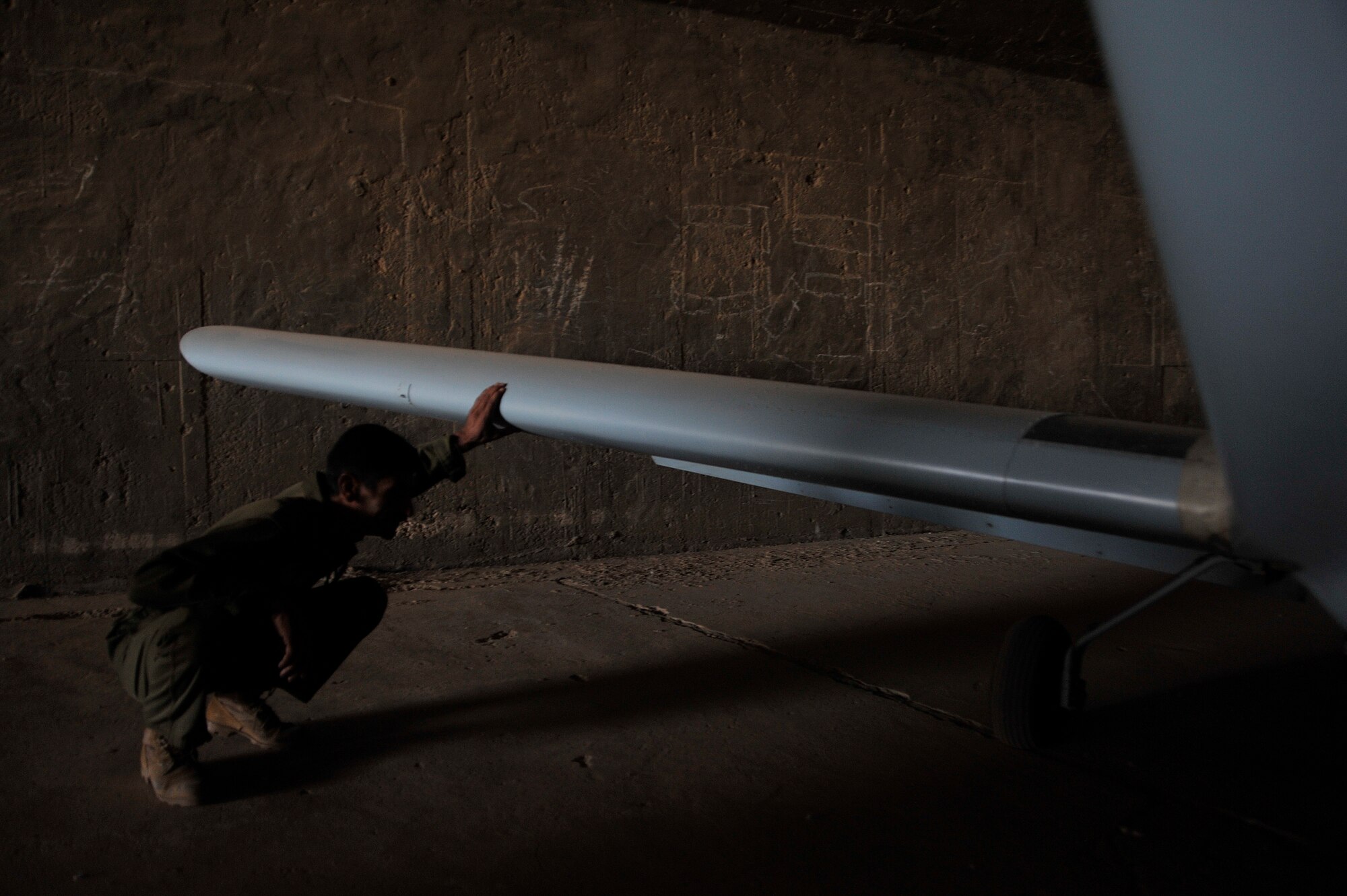 Iraqi air force airmen check their CH2000 for any damage after a sand storm, Oct. 24, 2010, at Ali Air Base, Iraq, after being transferred from Basrah Air Base by the Iraqi Ministry of Defense.  Iraqi air force Squadron 70 flies intelligence, surveillance and reconnaissance missions. After moving, Sq. 70 flew their first mission from Ali Base with U.S. Army AH-64 Apaches Oct 25, 2010, providing ISR security of the Hajj - an annual pilgrimage of citizens to Mecca - while also providing ISR support of a main supply route and oil pipeline. (U.S. Air Force photo by Senior Airman Perry Aston) (Released)