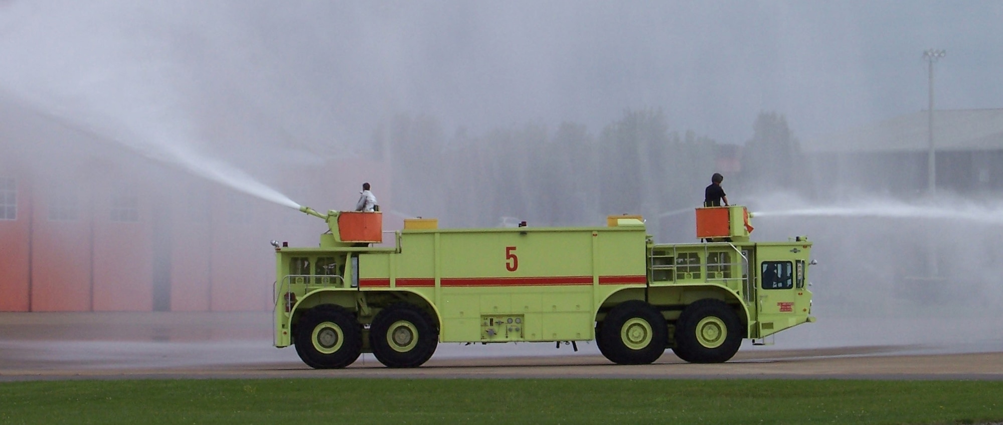 The Oshkosh P-15 Truck, Airport Rescue Fire Fighting (ARFF) is a 65 ton, 8x8 vehicle that was first fielded in 1977.  It carries 6,100 gallons of water and 515 gallons of foam, designed for all-weather operations at airfields for fire suppression.  Two 1,250 gpm pumps and two 1,200 gpm turrets deleiver the water and foam.  The Oshkosh P-15 ARFF is powereed by two Detroit Diesel engines.  The huge P-15 weighs 130,860 lbs, is 45 feet long, 10 ft wide and 13.8 feet tall.  (Air Force photo by Chief Master Sgt. Robert McCormack, 134 ARW Fire Dept.)