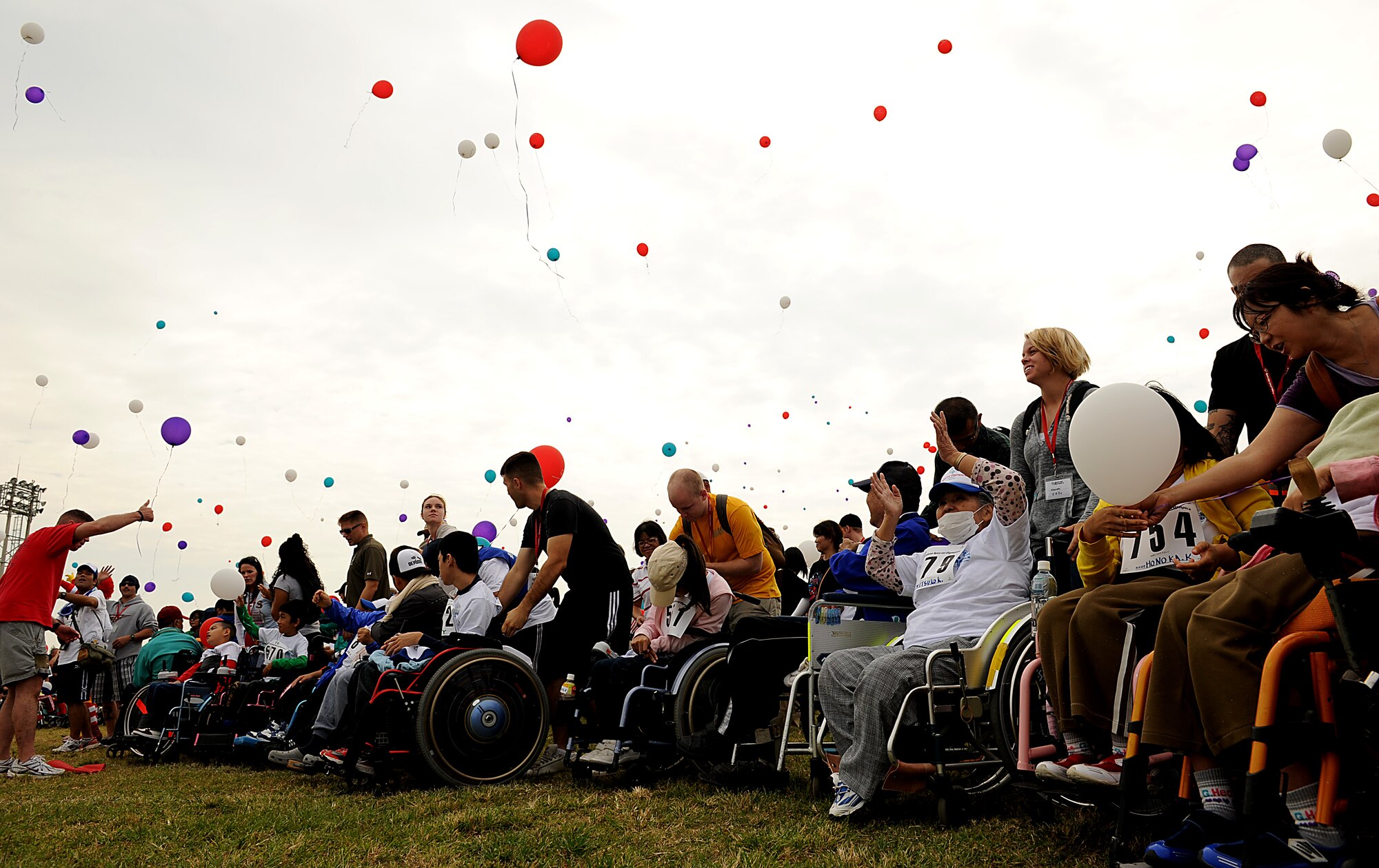 Special Olympics athletes and crowd releases balloons during the opening ceremony of the Kadena Special Olympics Nov. 6. About 99 percent of the participants are special needs children and adults from the Ryukyu Islands, as well as close to 15 athletes from DoDDS-Pacific/DDESS-Guam schools on Okinawa. (U.S. Air Force photo/Staff Sgt. Christopher Hummel)