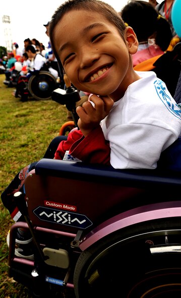 Reo Miyagi, a Kadena Special Olympics athlete, smiles in anticipation of the Kadena Special Olympics opening ceremony Nov. 6. KSO strives to foster thousands of experiences where fear and ignorance are replaced by openness and understanding. (U.S. Air Force photo/Staff Sgt. Christopher Hummel)