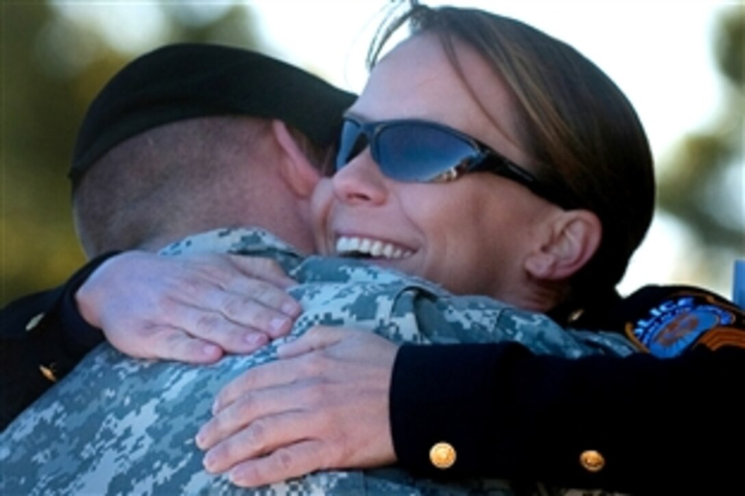 Police Sgt. Kimberly Munley and U.S. Army Staff Sgt. Zackary T. Filip, embrace during a remembrance ceremony on Fort Hood, Texas, Nov. 5, 2010. The ceremony honored 52 soldiers and civilians for their efforts to aid the wounded in the wake of the Nov. 5, 2009 shooting at Ft. Hood.