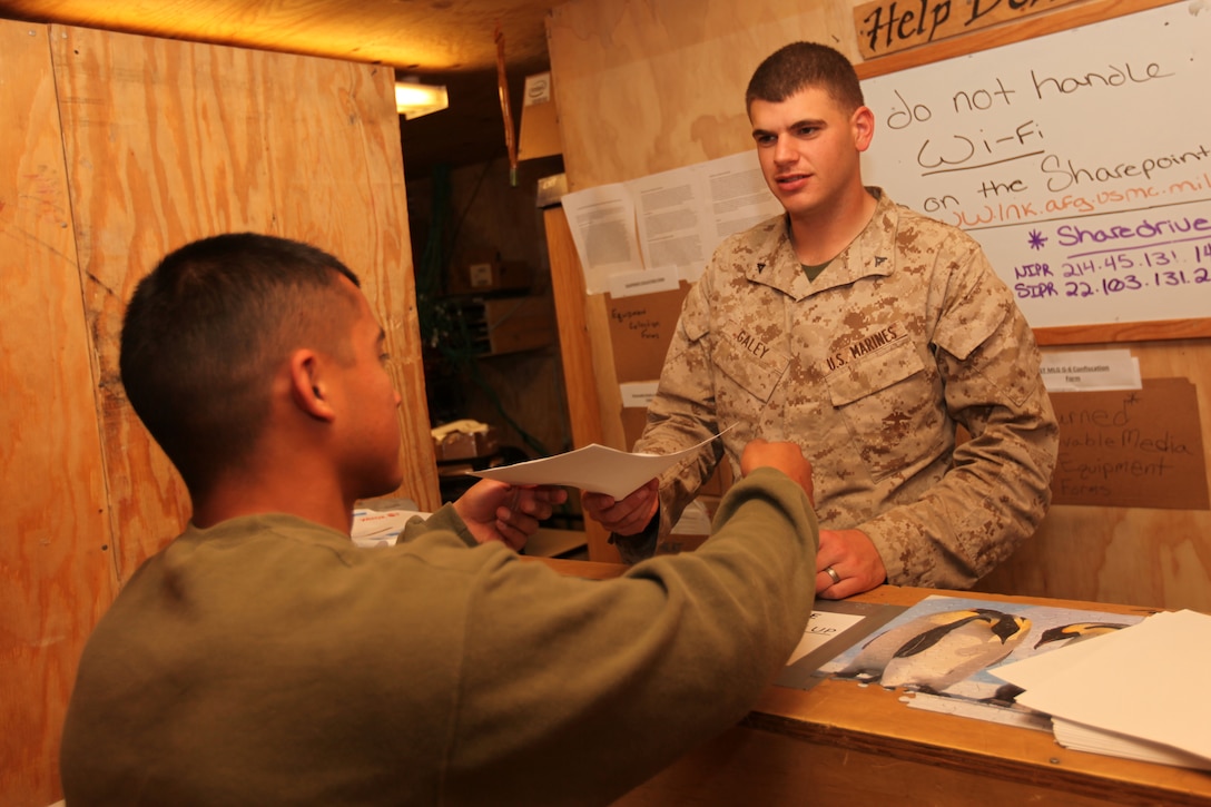 Lance Cpl. Dwayne A. Galey, a data specialist with Communications Platoon, Headquarters and Service Company, 1st Marine Logistics Group (Forward), helps out a Marine at the help desk at Camp Leatherneck, Afghanistan, Nov. 6. The communications Marines are responsible for maintaining radio, phone and computer equipment so Marines from 1st MLG (FWD) stay connected with each other and their families back home.