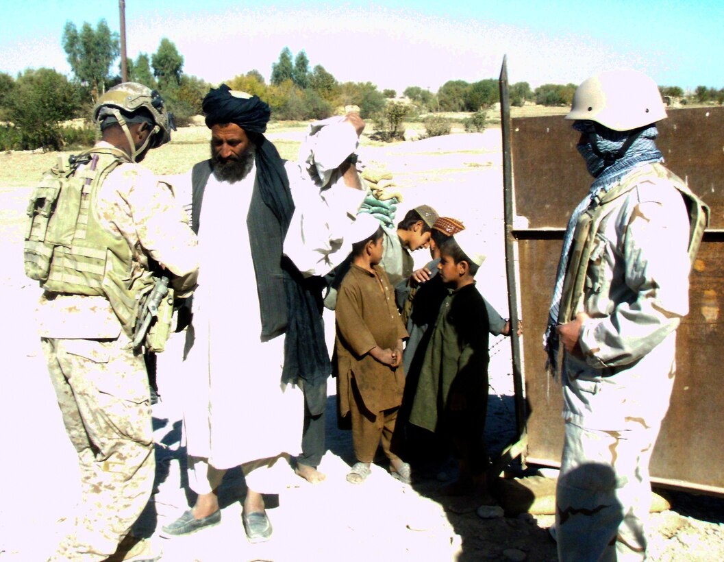 Local Afghans arrive at the medical clinic in Sangin, Afghanistan, Nov. 6. Run by coalition forces, the medical clinic is open to Afghan civilians every Saturday and offers free aid to those who need it.