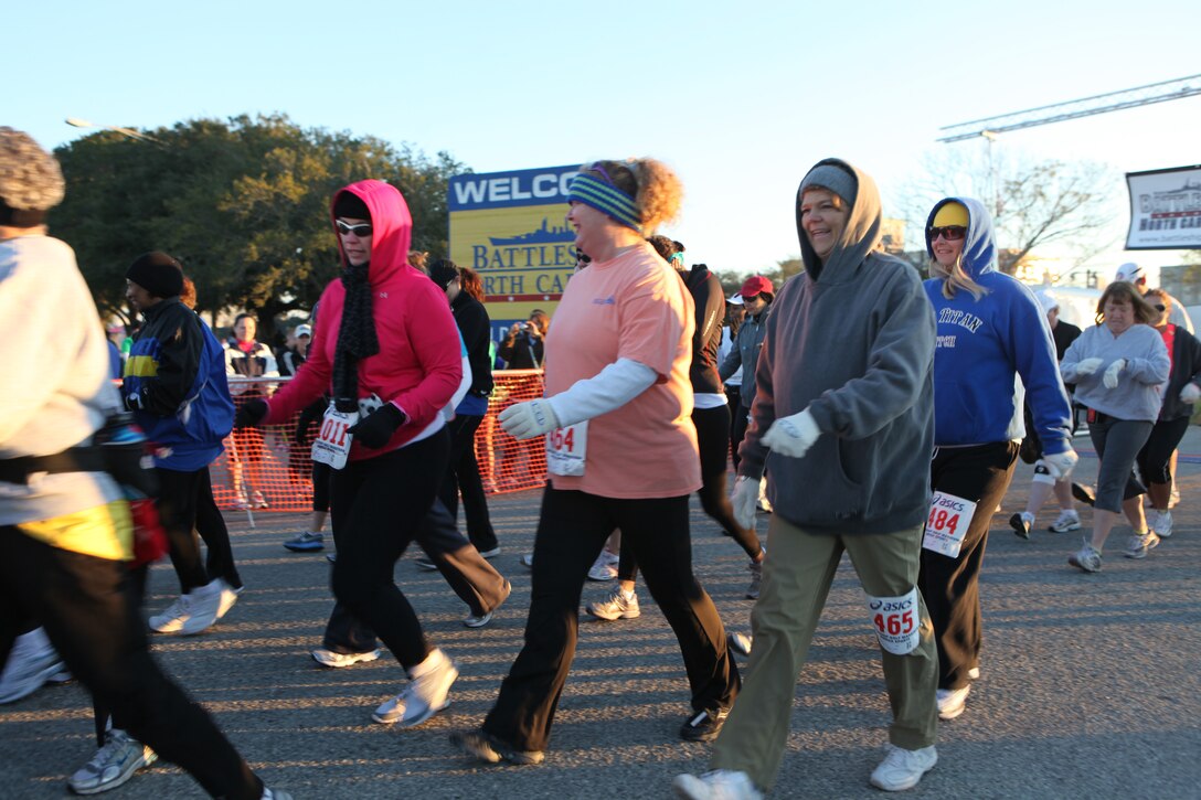 Women, dressed in warm clothes, walk part of the race course during the Carolina Sports Medicine’s 12th annual Battleship Half Marathon in Wilmington, N.C., Nov. 7.  The 13.1-mile race started and ended at the Battleship USS North Carolina and was dedicated to the men and women who have served and are currently serving in the United States Armed Forces.