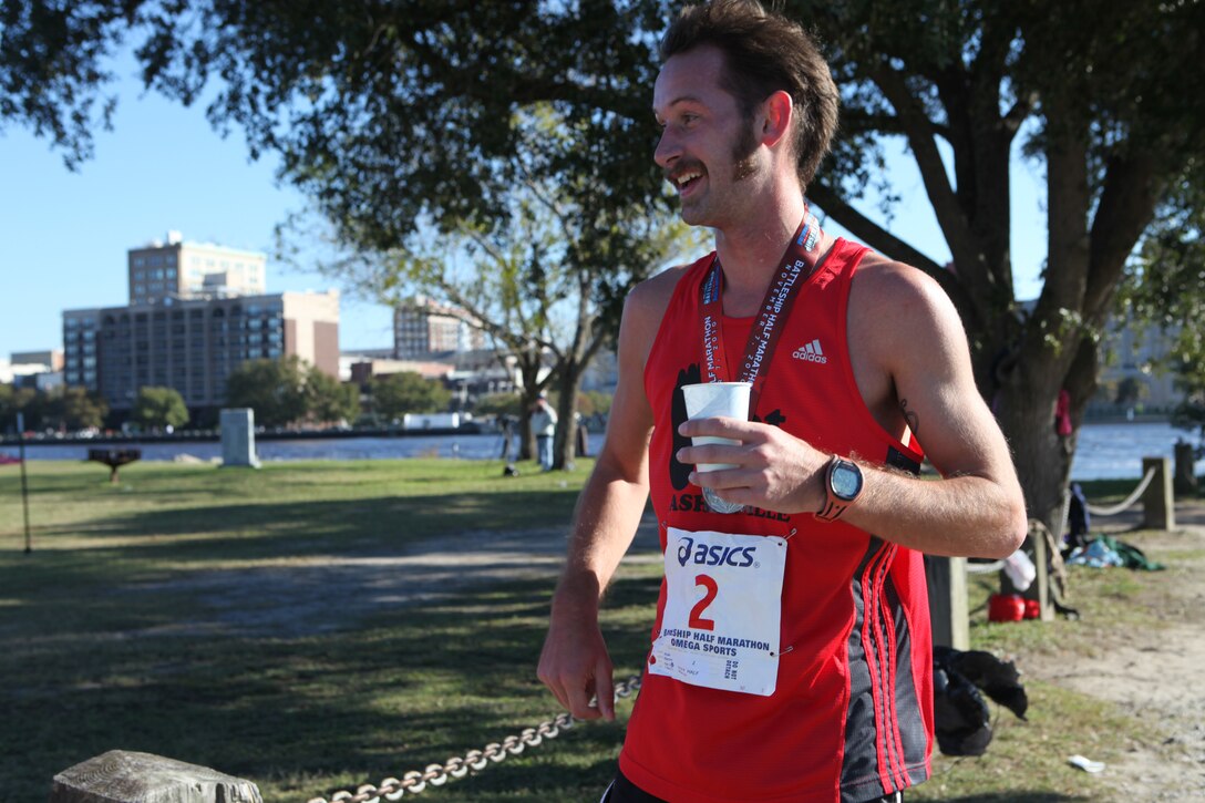 Aaron Kolk, the winner of the Carolina Sports Medicine’s 12th annual Battleship Half Marathon in Wilmington, N.C., cools down with a drink after completing the race in 1 hour, 12 minutes and 24 seconds, Nov. 7.  The 13.1-mile race started and ended at the Battleship USS North Carolina and was dedicated to the men and women who have served and are currently serving in the United States Armed Forces.