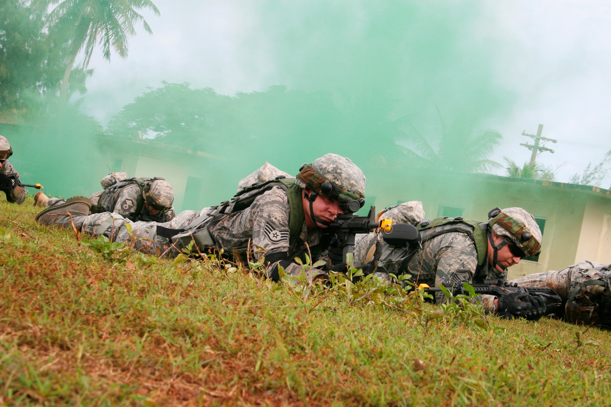 Members of Alpha Fire Team, Staff Sgt. David Burrus and Master Sgt. Shawn Bendixson, prepare to execute the high crawl from a defensive fighting position as part of Individual Movement Technique (IMT) training here at the Combat Readiness School (CRS) 20-day course recently. (Photo by Sara Mortimer)