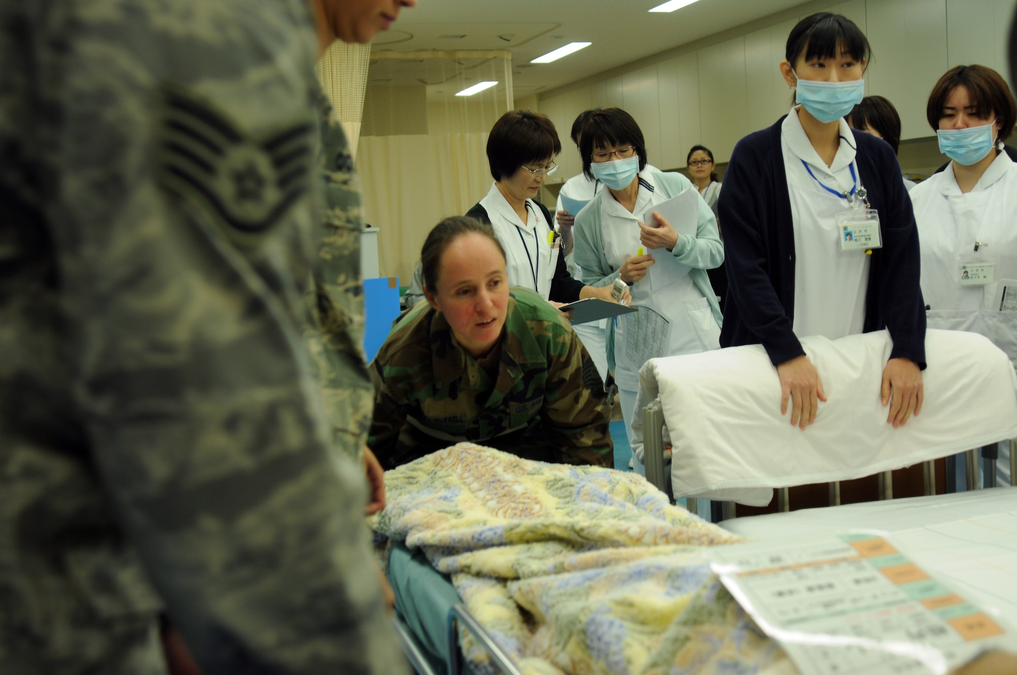 A 35th Medical Group airman prepares to move a patient from stretcher to bed at the new Misawa City Hospital. Misawa City opened its new hospital last week and requested military assistance in transporting patients from the old hospital to the new building. More than 20 service members from Naval Air Facility Misawa and the 35th Medical Group assisted with the transfer. (U.S. Navy photo by Petty Officer 2nd Class Matthew Bradley/ Released)


