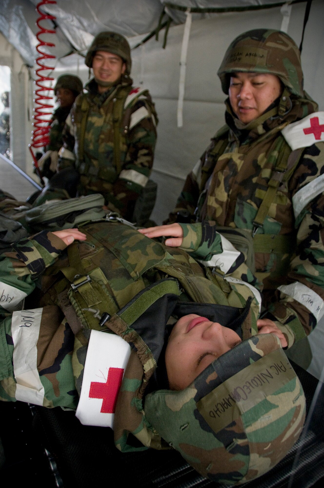 Medics from the 35th Medical Group practice patient decontamination on Airman 1st Class Nicole Camacho, 35th MDG health services apprentice, at Misawa Air Base, Japan, Nov. 8, 2010, during a base operational readiness exercise. Simulated patents exposed to chemicals during the exercise must process through the hospital tent before they can be medically treated. (U.S. Air Force photo by Senior Airman Jessica Lockoski/Released)