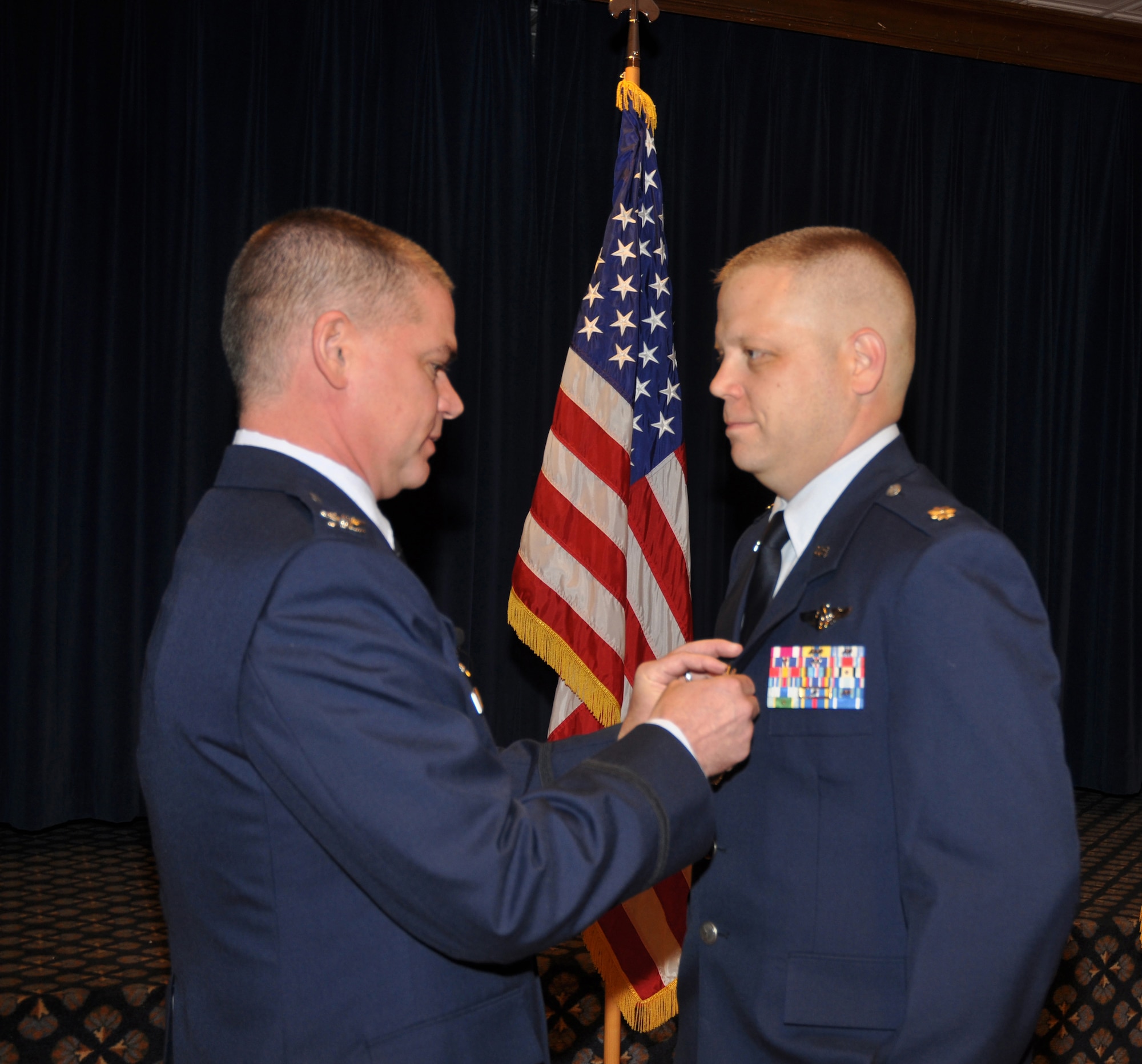 Three 302nd Airlift Wing members were recognized Nov. 7 with service medals during a semi-annual commander's call at Peterson Air Force Base, Colo. Col. Jay Pittman, wing commander, presented the Air Force Meritorious Service Medal to Maj. Bryan Hutcheson, the Air Force Meritorious Service Medal first oak leaf cluster to Senior Master Sgt. Kenneth Lohle and the Joint Service Achievement Medal to Capt. Joseph Catalino. (U.S. Air Force photo/Tech. Sgt. Daniel Butterfield)
