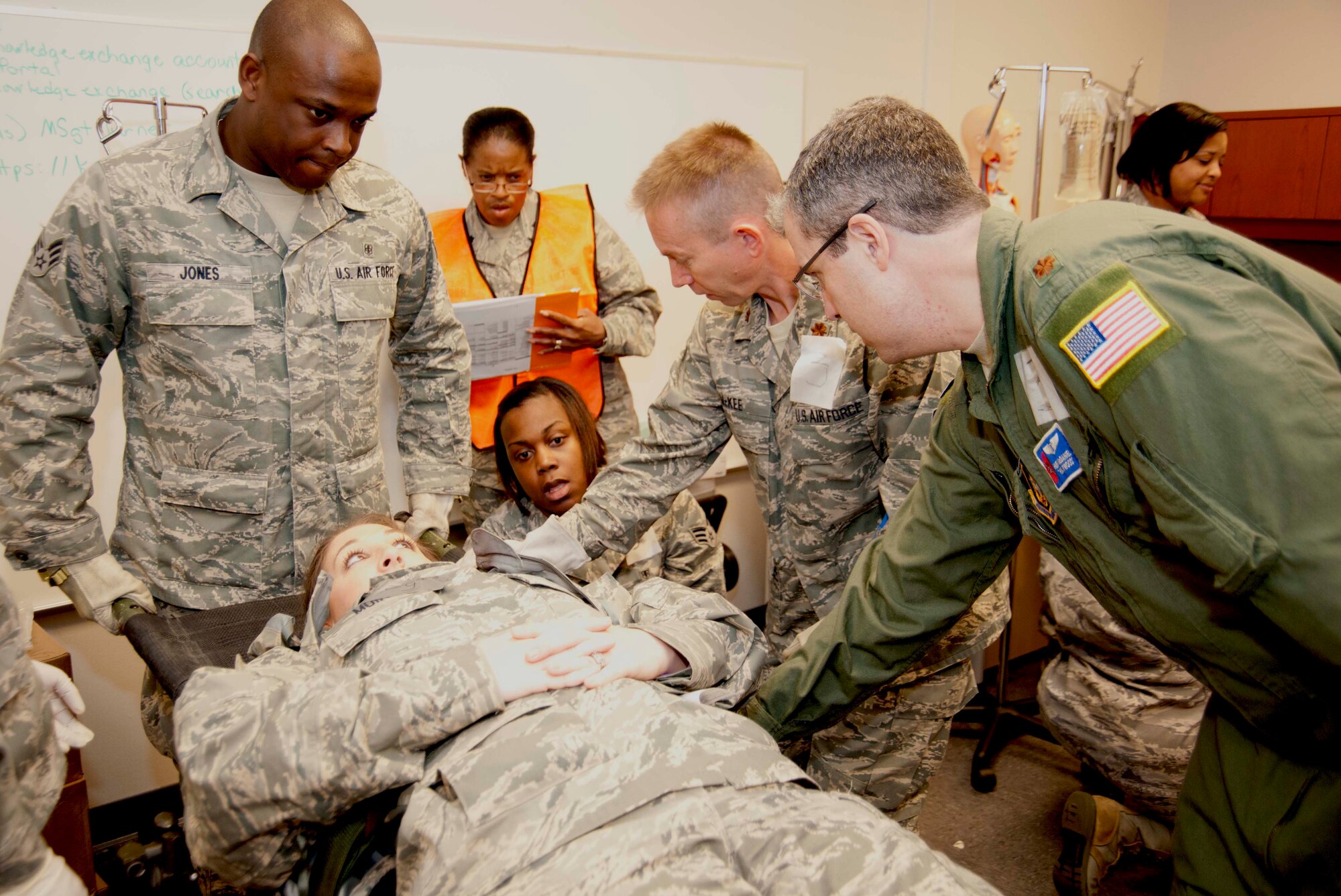 Majs. Huey McDaniel (far right), 403rd Aeromedical Staging Squadron flight surgeon, and John McKee, 403rd ASTS nurse, assess the condition of one of their "patients" during a mass casualty exercise. The "casualty" in question, Senior Airman Jennifer Muir, a 403rd ASTS dental technician, was suffering from a simulated pain in her left thigh. The mass casualty exercised was conducted during the November Unit Training Assembly in preparation for the 403rd Wing’s upcoming Operation Readiness Inspection.