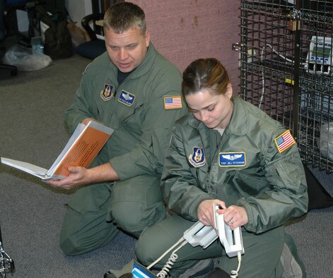 JOINT BASE LEWIS-MCCHORD, Wash.- Master Sgt. Paul Melkers and Tech. Sgt. Jill Petersen, 446th AES flight medics, run visual inspections on medical equipment, like the defibrillator, which the Reservists use to detect abnormal electrical activity in their patients' hearts. The continuous training the 446th AES Reservists undergo was one of the factors that earned the unit the Outstanding Aeromedical Evacuation Squadron Award by the Air Force Reserve Command in September 2010. (U.S. Air Force Photo/Staff Sgt. Javier Cruz)