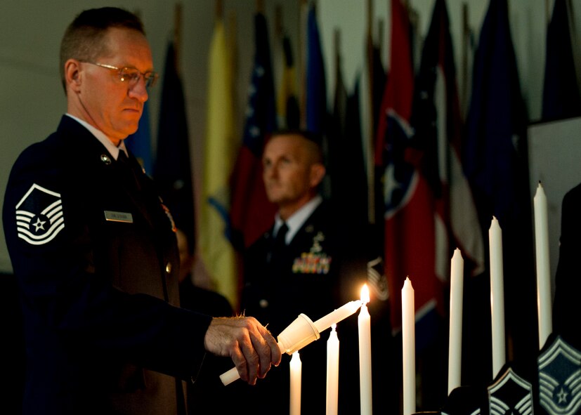 Master Sgt. Stefan Halushka, 919th Logistics Readiness Squadron, lights the ceremonial candle during the 919th Special Operations Wing senior NCO induction ceremony Nov. 6 at Duke Field.  The ceremony also inducted new staff sergeants within the wing.  46 staff sergeants and 30 master sergeants were inducted. (Air Force photo/Tech Sgt. Samuel King Jr.)