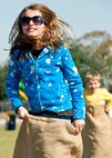 A sister and brother race each other in potato sacks during the 919th Special Operations Wing “family day” event at Duke Field, Nov. 6.   The Family Day event brought reservists and their families together for food, games and music. (Air Force photo/Tech. Sgt. Samuel King Jr.)