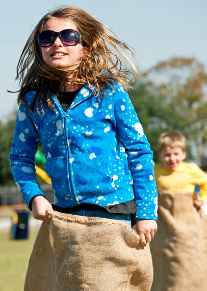 A sister and brother race each other in potato sacks during the 919th Special Operations Wing “family day” event at Duke Field, Nov. 6.   The Family Day event brought reservists and their families together for food, games and music. (Air Force photo/Tech. Sgt. Samuel King Jr.)