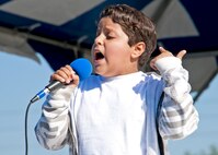 Steven Fireman, age 10, belts out “Black Velvet” during a solo performance at the 919th Special Operations Wing “family day” event at Duke Field, Nov. 6.   The Family Day event brought reservists and their families together for food, games and music. (Air Force photo/Tech. Sgt. Samuel King Jr.)