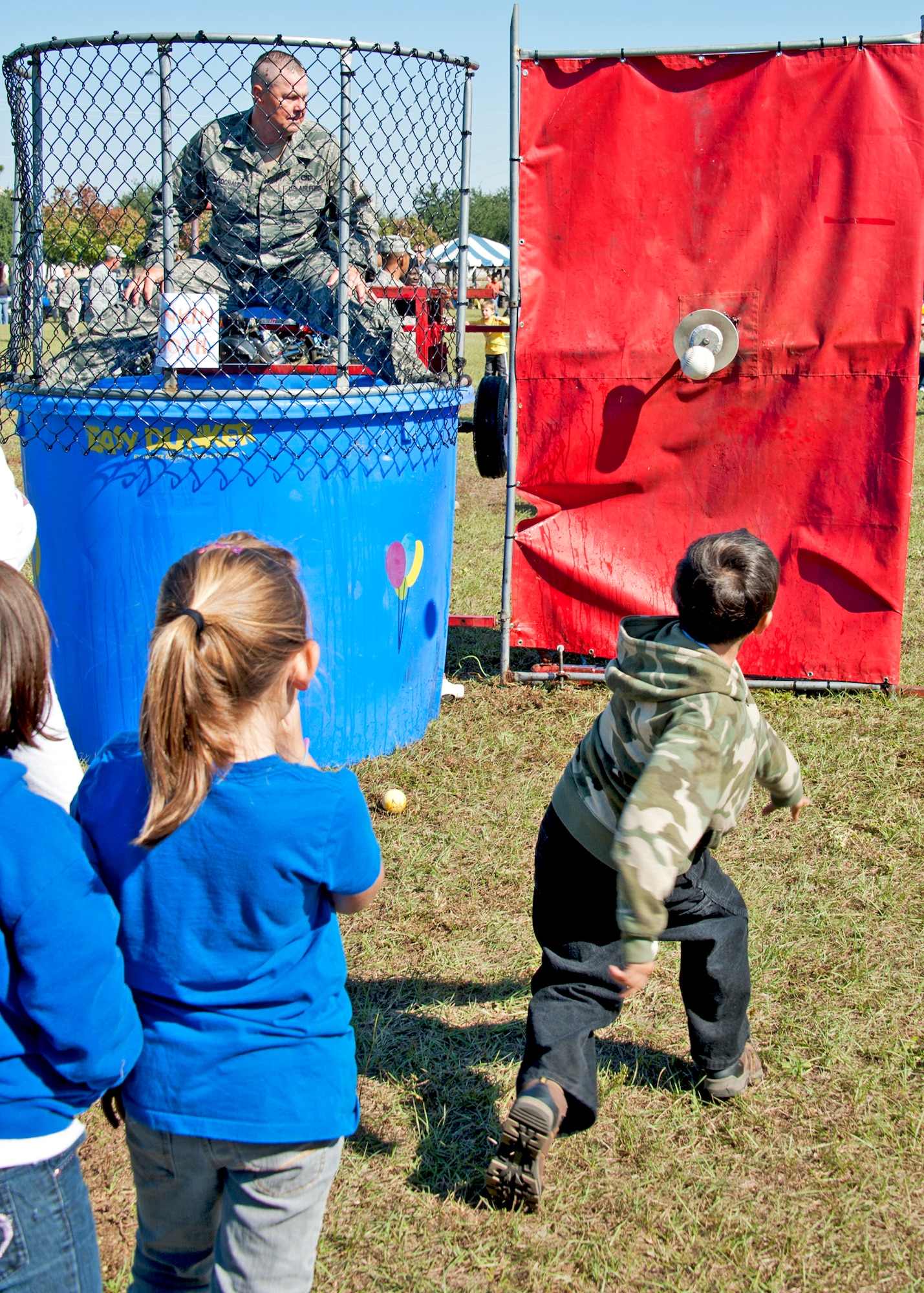 Lt Col. Scott McDonald ,919th Logistics Readiness Squadron commander, prepares for a cold dip in the dunking booth at the 919th Special Operations Wing “family day” event at Duke Field, Nov. 6.   The Family Day event brought reservists and their families together for food, games and music. (Air Force photo/Tech. Sgt. Samuel King Jr.)
