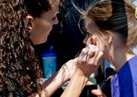 April Crooks, 919th Force Support Squadron, paints a bear on an attendee’s face during the 919th Special Operations Wing “family day” event at Duke Field, Nov. 6.   The Family Day event brought reservists and their families together for food, games and music. (Air Force photo/Tech. Sgt. Samuel King Jr.)