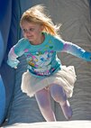 MacKenzie Lisenbee, three-year-old daughter of Senior Airman Corey Lisenbee, 623rd Air Operations Center, plays on the bouncy castle at the 919th Special Operations Wing “family day” event at Duke Field, Nov. 6.   The Family Day event brought reservists and their families together for food, games and music. (Air Force photo/Tech. Sgt. Samuel King Jr.)