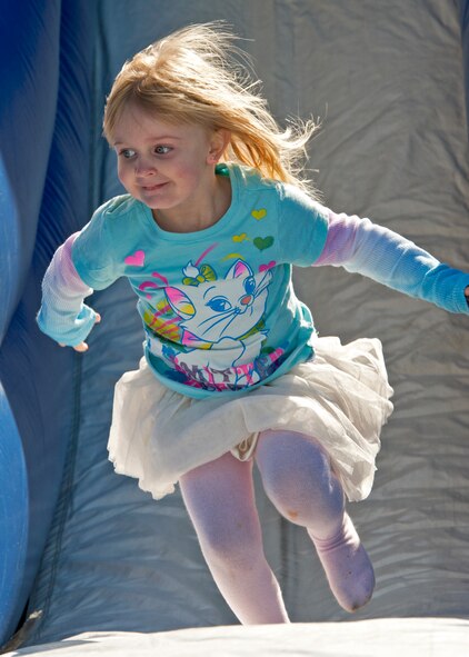 MacKenzie Lisenbee, three-year-old daughter of Senior Airman Corey Lisenbee, 623rd Air Operations Center, plays on the bouncy castle at the 919th Special Operations Wing “family day” event at Duke Field, Nov. 6.   The Family Day event brought reservists and their families together for food, games and music. (Air Force photo/Tech. Sgt. Samuel King Jr.)