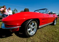 Chief Master Sgt. Mike Klausutis’s red 1964 corvette draws attention during the car show portion of the 919th Special Operations Wing “family day” event at Duke Field, Nov. 6.   The Family Day event brought reservists and their families together for food, games and music. (Air Force photo/Tech. Sgt. Samuel King Jr.)