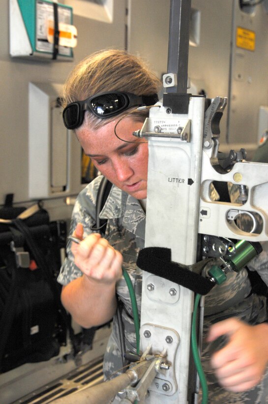 BUSH FIELD, Augusta, Ga.- Staff Sgt. Karissa Kvam, a Reservist with the 446th Aeromedical Evacuation Squadron, McChord Field, secures a litter stantion aboard a C-17 Globemaster III aircraft, during her preparation for a training mission, July 19. Sergeant Kvam's unit, the 446th AES was honored by AFRC with its Outstanding Aeromedical Evacuation Squadron Award, for having top notch Reservists who led a Turkisk aeromedical evacuation team on the C-17 Globemaster aircraft and patient support pallet. The team copped a perfect score (400/400) and the C-17 trophy. (U.S. Air Force photo/Senior Master Sgt. Dennis Martin)