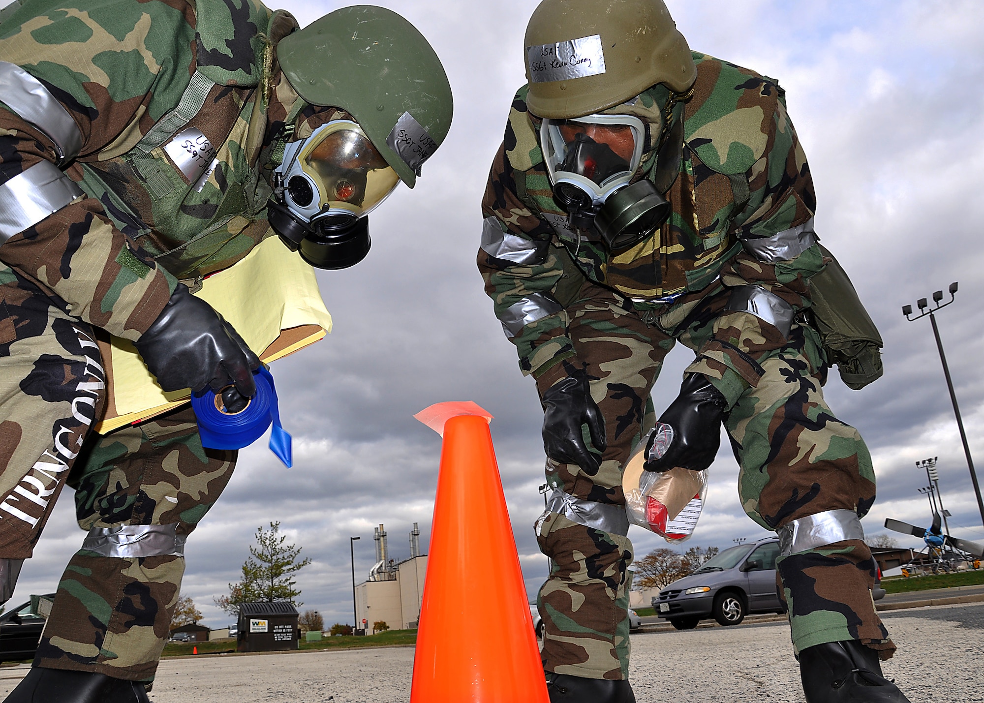 JOINT BASE MCGUIRE-DIX-LAKEHURST, N.J. ? Staff Sgt. James Moore, 514th Air Mobility Wing, and Staff Sgt. Kevin Curry, 514th Aeromedical Staging Squadron, check for chemical contamination on M-8 Chemical Agent Detection Paper while performing post-attack reconnaissance during a mobility exercise here Nov. 6, 2010. (U.S. Air Force photo/Tech. Sgt. Shawn J. Jones)
