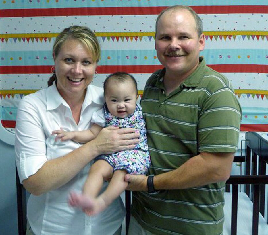 Senior Master Sgt. Lance Gustafson and his wife Denice celebrate the adoption of their new daughter, Abi, during the final stage of the process in Taiwan earlier this year.  This is the second adoption for Sergeant Gustafson, a loadmaster superintendent with the 313th Airlift Squadron.  He and Denice adopted a girl from Kazakhstan four years ago.  They also have three biological children.  "Kids bring a lot of joy to your life," said Sergeant Gustafson. (courtesy photo/Senior Master Sgt. Lance Gustafson)