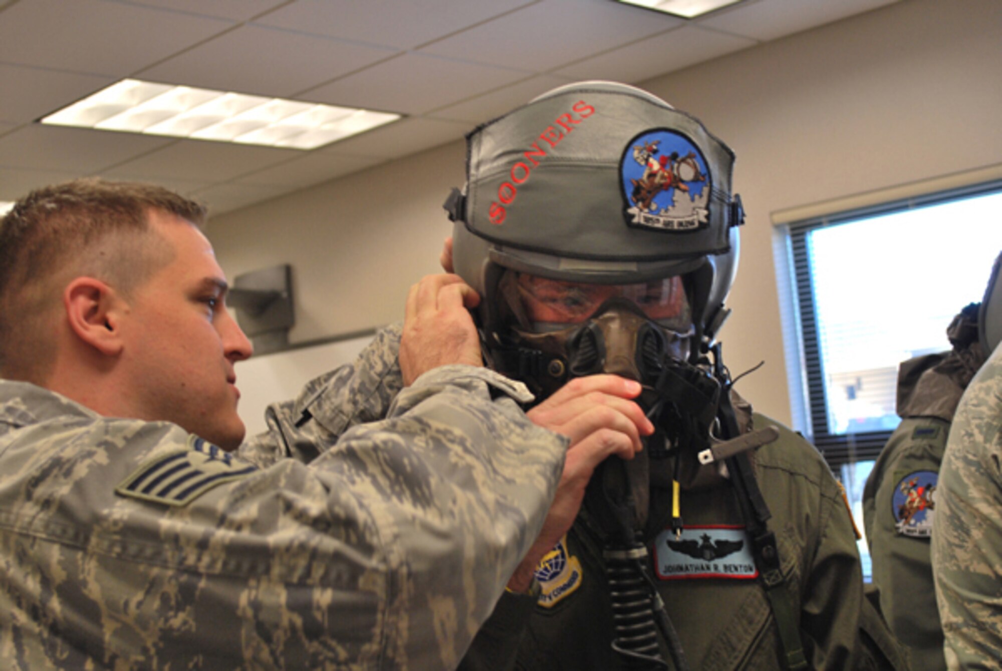 Aircrew Fight Equipment Technician, Staff Sergeant Dustin Nottnagel guides 137th Operations Group’s Lt. Col. Johnathan Benton through a preflight equipment inspection.