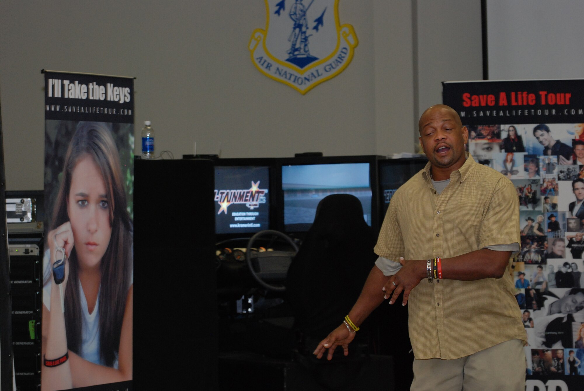 Mr. Oscar J. Perry, Save a Life Tour manager, talks about the effect of alcohol while driving before having 94th Airlift Wing Airmen try their skills on the simulator that simulates the effect of alcohol content in the body.  (U.S. Air Force photo/Master Sgt. Stan Coleman) 