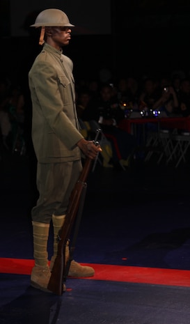 A Marine dressed in World War I garb stands at parade rest during the pageant at the Marine Corps Birthday Ball held at the IronWorks Gym here Monday. During the pageant, Marines appeared in uniforms from every different era of the Marine Corps.
