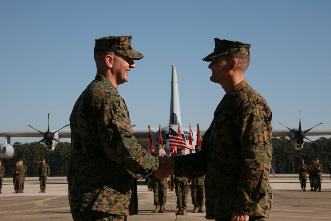 Col. Andrew G. Shorter and Col. Russell A.C. Sanborn shake hands after the passing of the flag portion of the Marine Aircraft Group 14 change of command ceremony Monday.