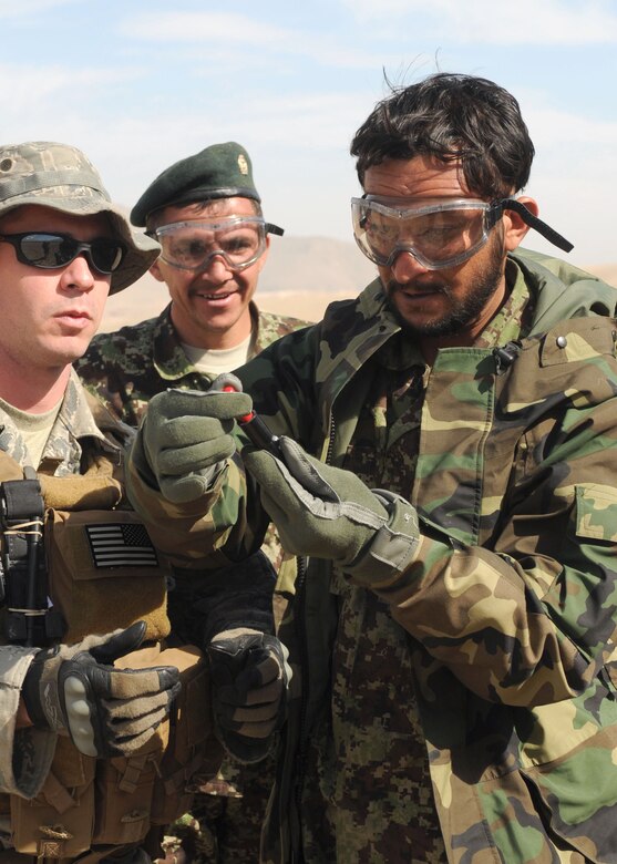 Afghan life support airmen practice using signaling devices. They will begin teaching this skill to Afghan air force pilots so they know how to signal for rescue. (U.S. Navy photo/Petty Officer 3rd Class Jared Walker) 